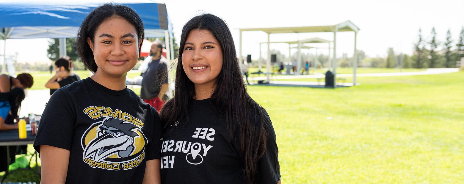 Two Butte College Studens are shown smiling on campus.